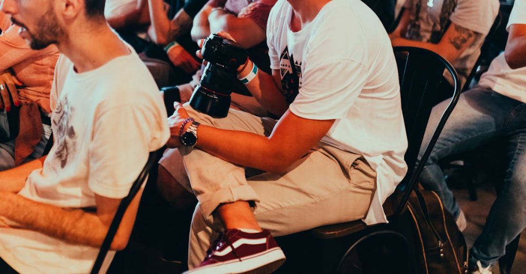 A group of adults attentively listening at an indoor seminar or conference.